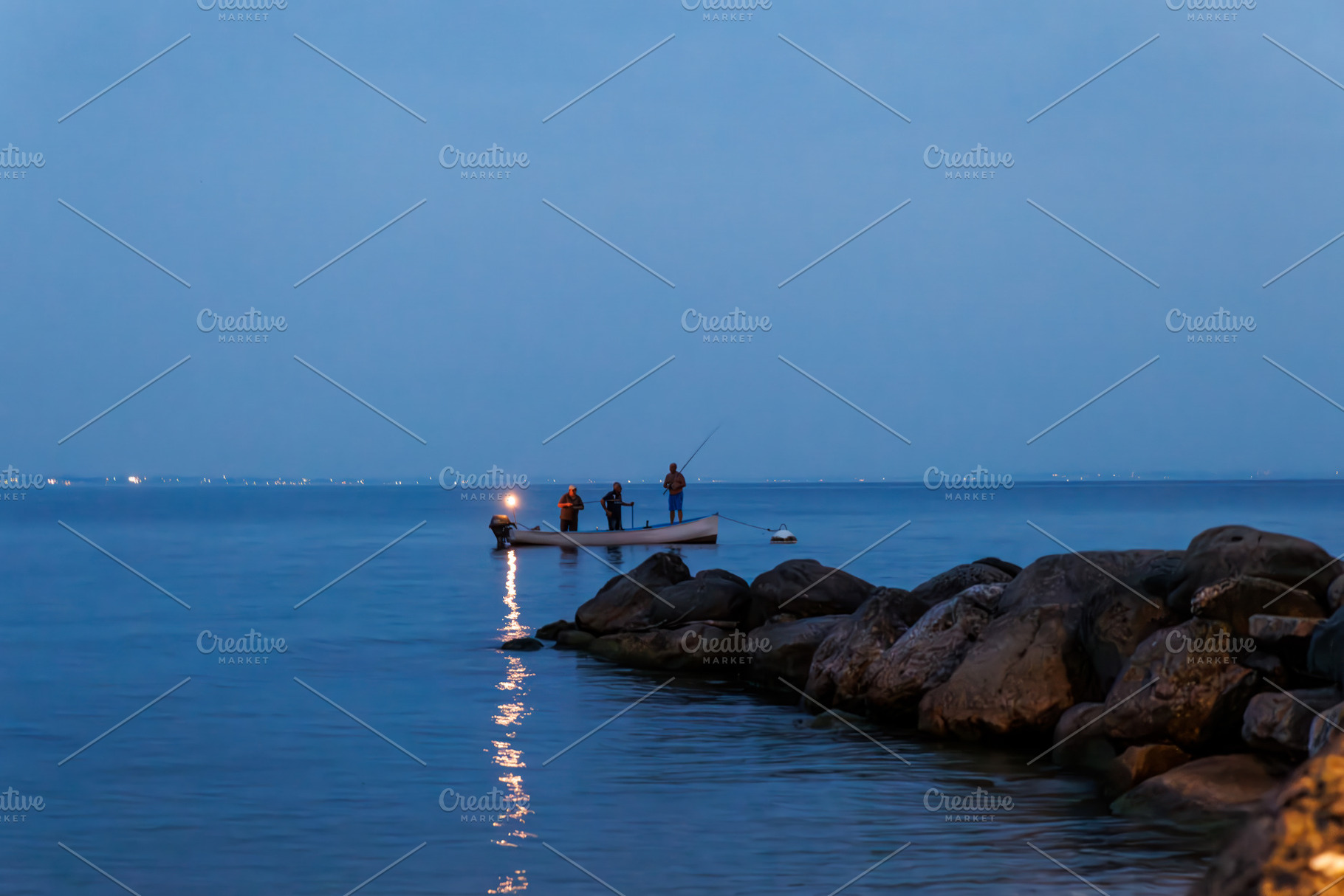 Silhouette of man fishing on lake Garda, a Nature Photo by Bepslabor