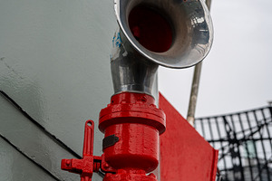 Metal ship horn mounted on a military vessel with red piping, an Architecture Photo by GoodGoods