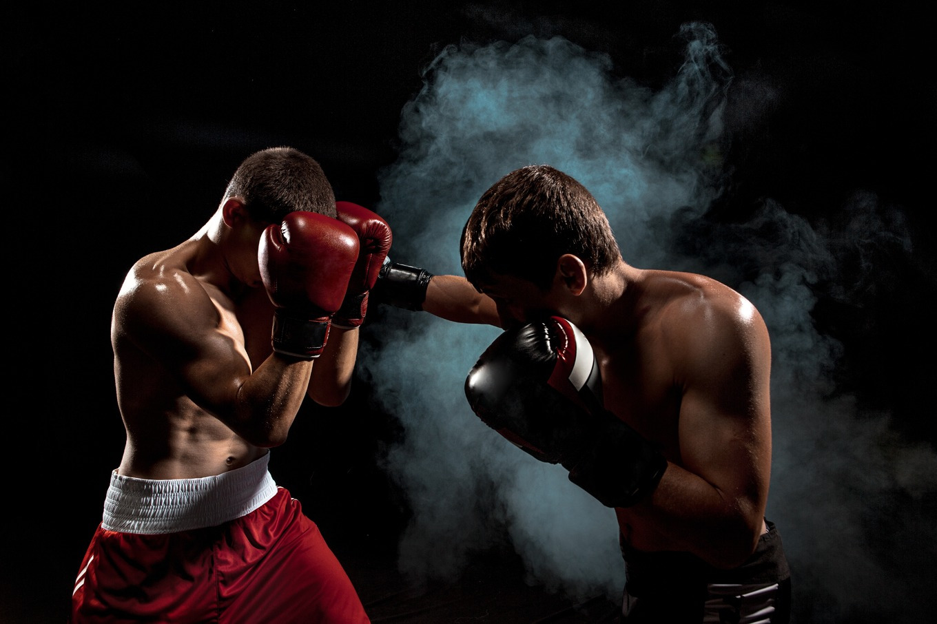 Two professional boxer boxing on black smoky background featuring ...