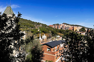 Scenic view of Park Guell in Barcelona Spain under a clear blue sky, a Photo by AS photostudio