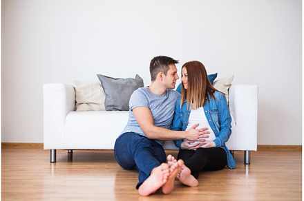 Pregnant woman and her partner, a Person Photo by HalfPoint