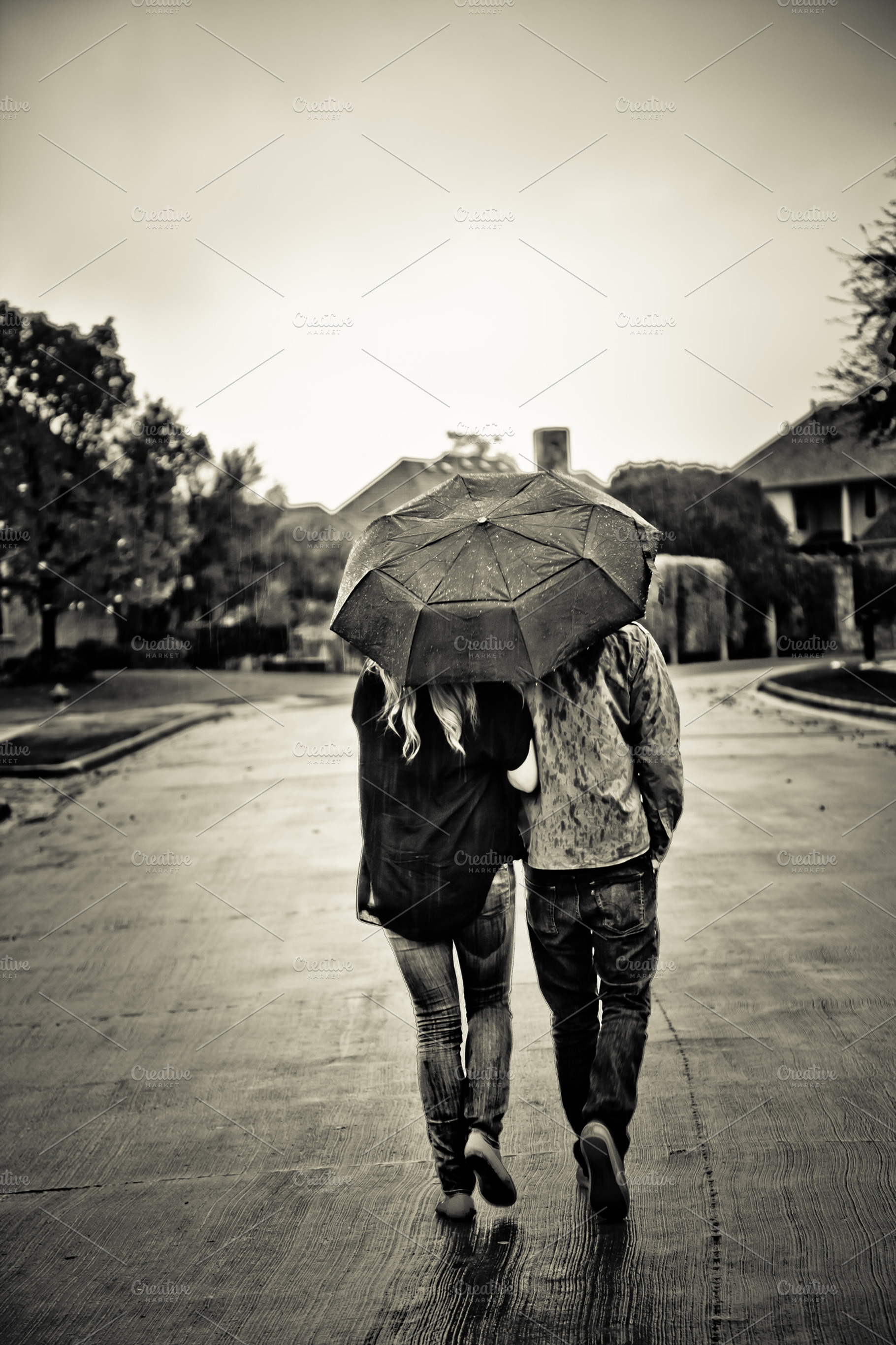 Couple with Umbrella Walking in Rain