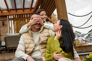 Girl covering fathers eyes with