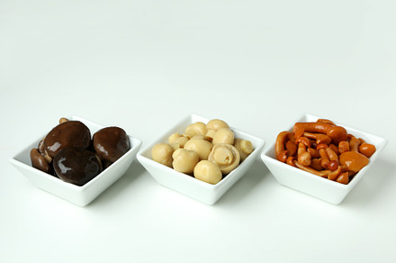 Bowls of marinated mushrooms on white background, a Food & Drink Photo by AtlasStudio PRO