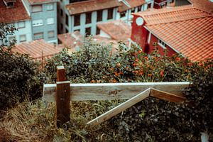 Rustic fence with blurred rooftops, an Architecture Photo by SkyNext