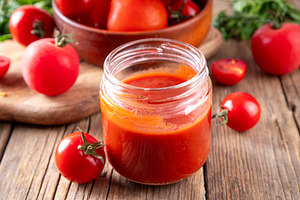 Homemade tomato paste, puree or ketchup in a small glass jar, a Food & Drink Photo by Rimma