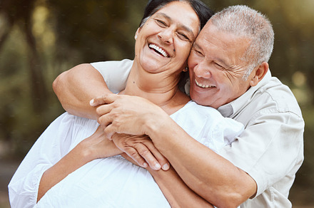 Love, senior couple and hug being happy, smile and bonding for marriage, anniversary and loving together outdoor. Romance, elderly man and mature woman doing embrace, relationship or enjoy retirement, a Photo by Peopleimages.com