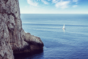 Lonely sailboat sailing on the sea, a Nature Photo by BOOCYS