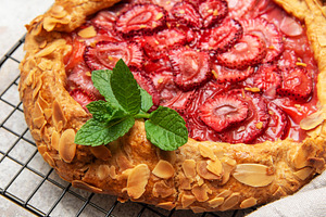 Delicious homemade strawberry galette cooling on wire rack, a Food & Drink Photo by Olena Rudo