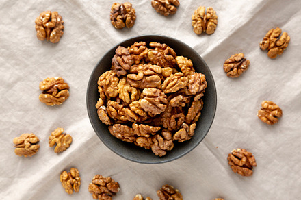 Raw Walnut Halfs in a Bowl, top view.