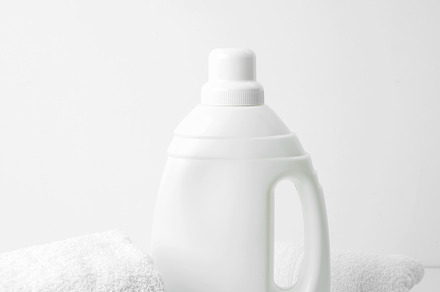 Laundry detergent branding mock up and clean white towels. Household cleaning a