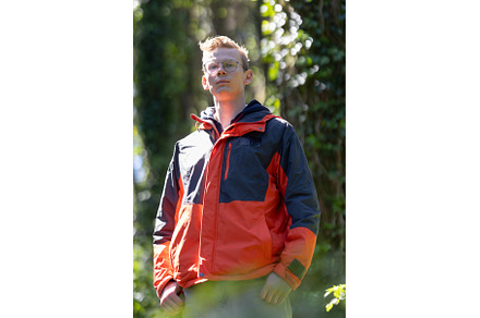 Man in Red and Blue Jacket Standing, a Nature Photo by Barcelona_dreams