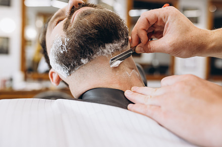 Man getting haircut at the barbershop. Professional barber at work process. Bea, a Person Photo by Volodymyr Melnyk