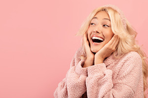 Wow offer. Amazed lady with open mouth touching her cheeks with hands and looki, a Photo by Prostock-Studio