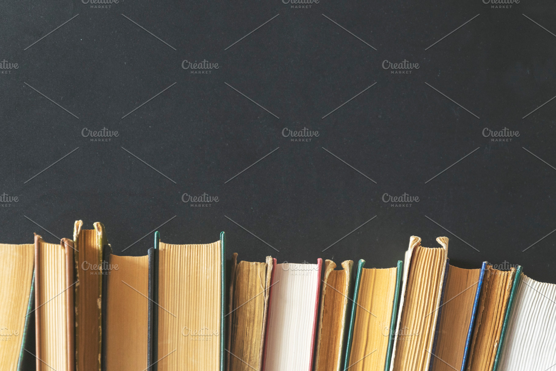 Old books on a black background, a Business Photo by Ti-Di