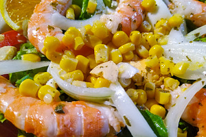 Colorful shrimp salad with corn and orange slices, a Food & Drink Photo by DanFLCreativo