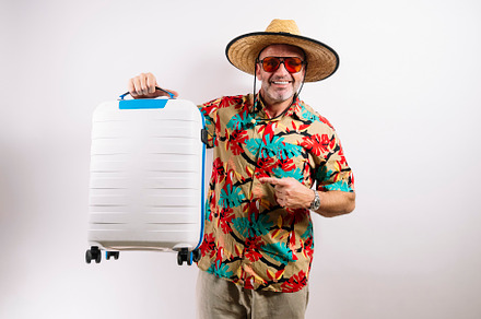 Smiling tourist holding white suitcase