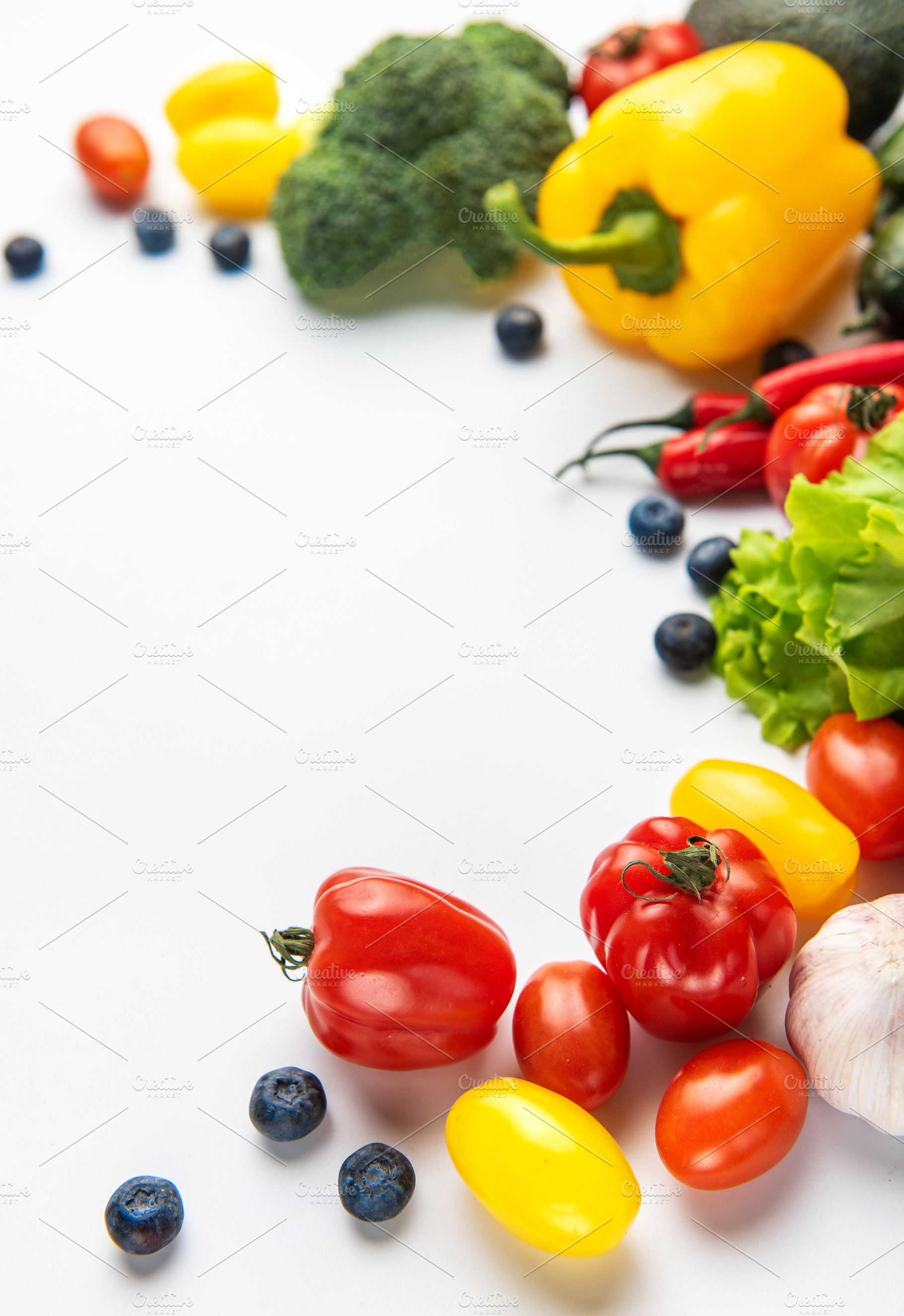 Fresh organic vegetables and fruit border on white, a Food & Drink Photo by Olena Rudo