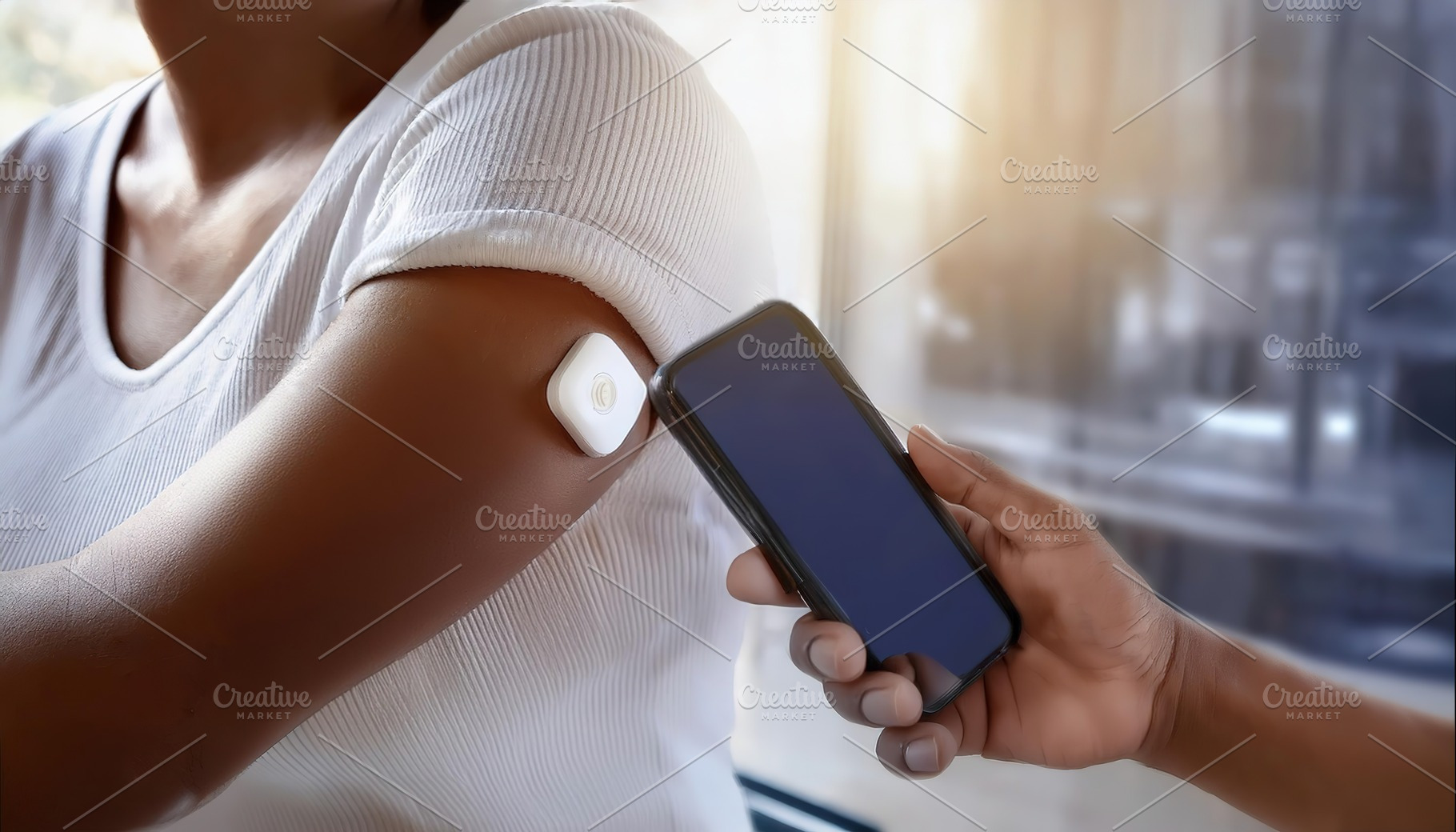 Person scanning a medical patch with smartphone, a Health & Medical Photo by Igor Tichonow