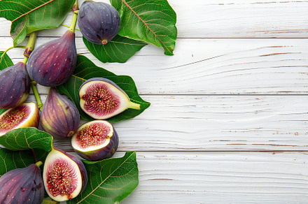 Fresh figs with copyspace on wooden table, a Food & Drink Photo by AlyaAnd