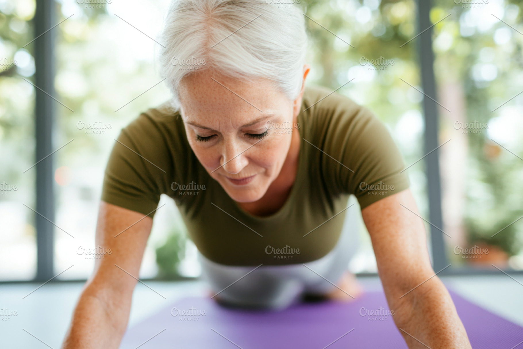 Middle-aged woman practicing yoga on, a Photo by Dvoevnore photos