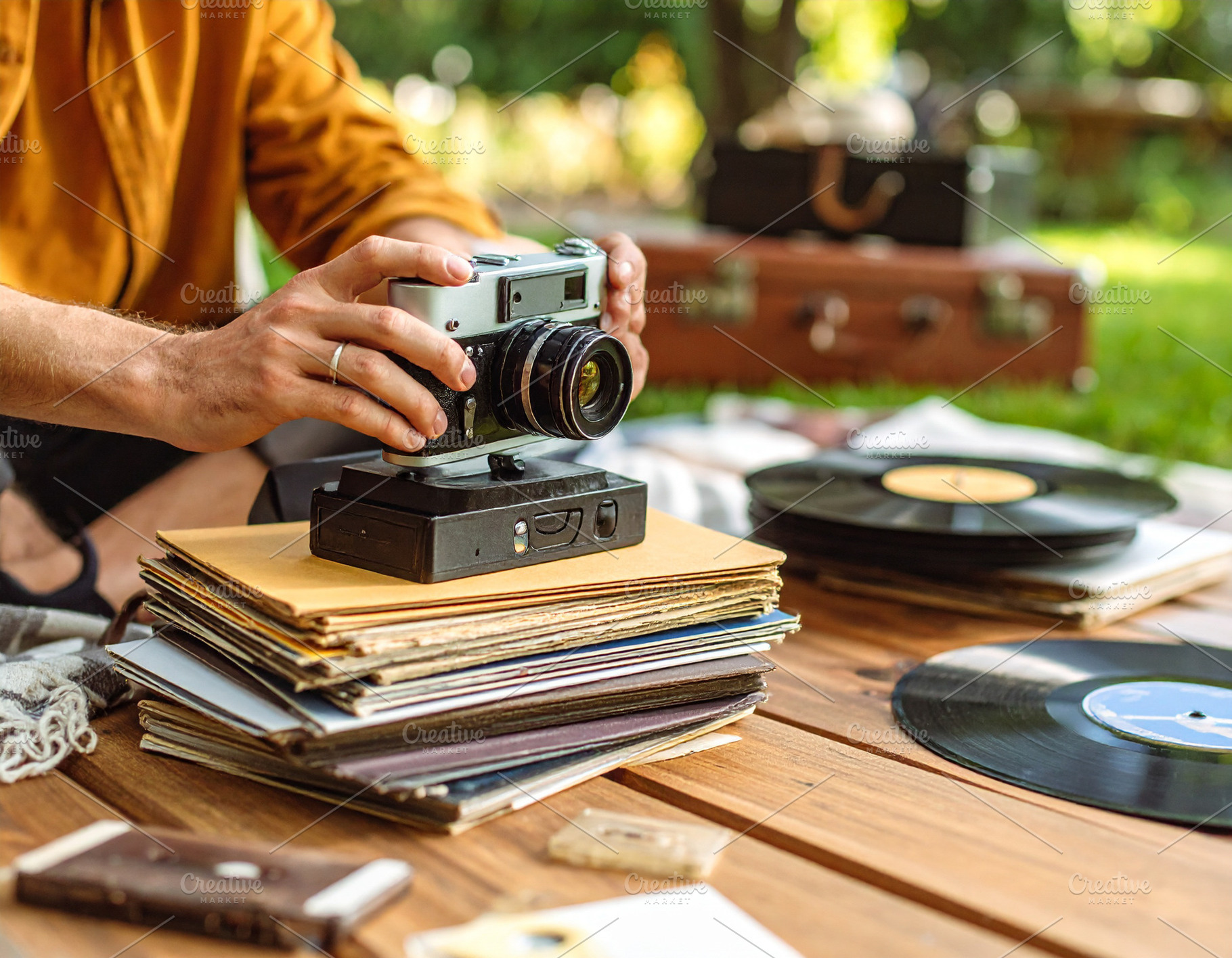 Person captures memories using a classic film camera surrounded, a Person Photo by DanFLCreativo