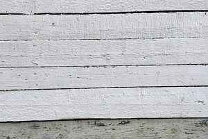 A textured wooden wall with alternating white and gray planks, showing signs of, a Nature Photo by Textures & Backgrounds