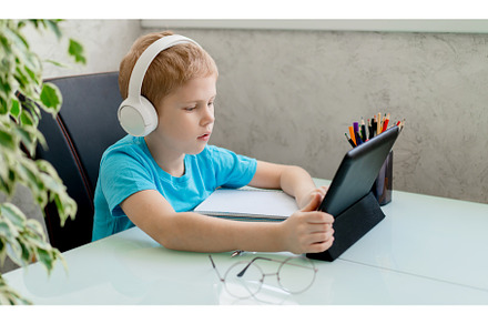 Young boy learn by tablet at home, a School & Education Photo by Ksenia Neyman