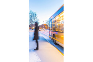 Blurred figure on bus stop waiting, a Transportation Photo by Lermont51
