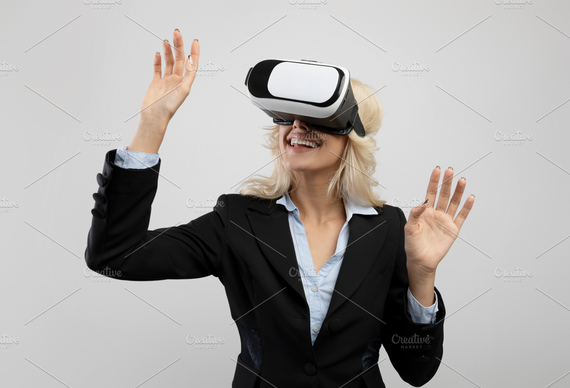 Business and technologies. Young businesswoman in VR headset experiencing virtu, a Photo by Prostock-Studio