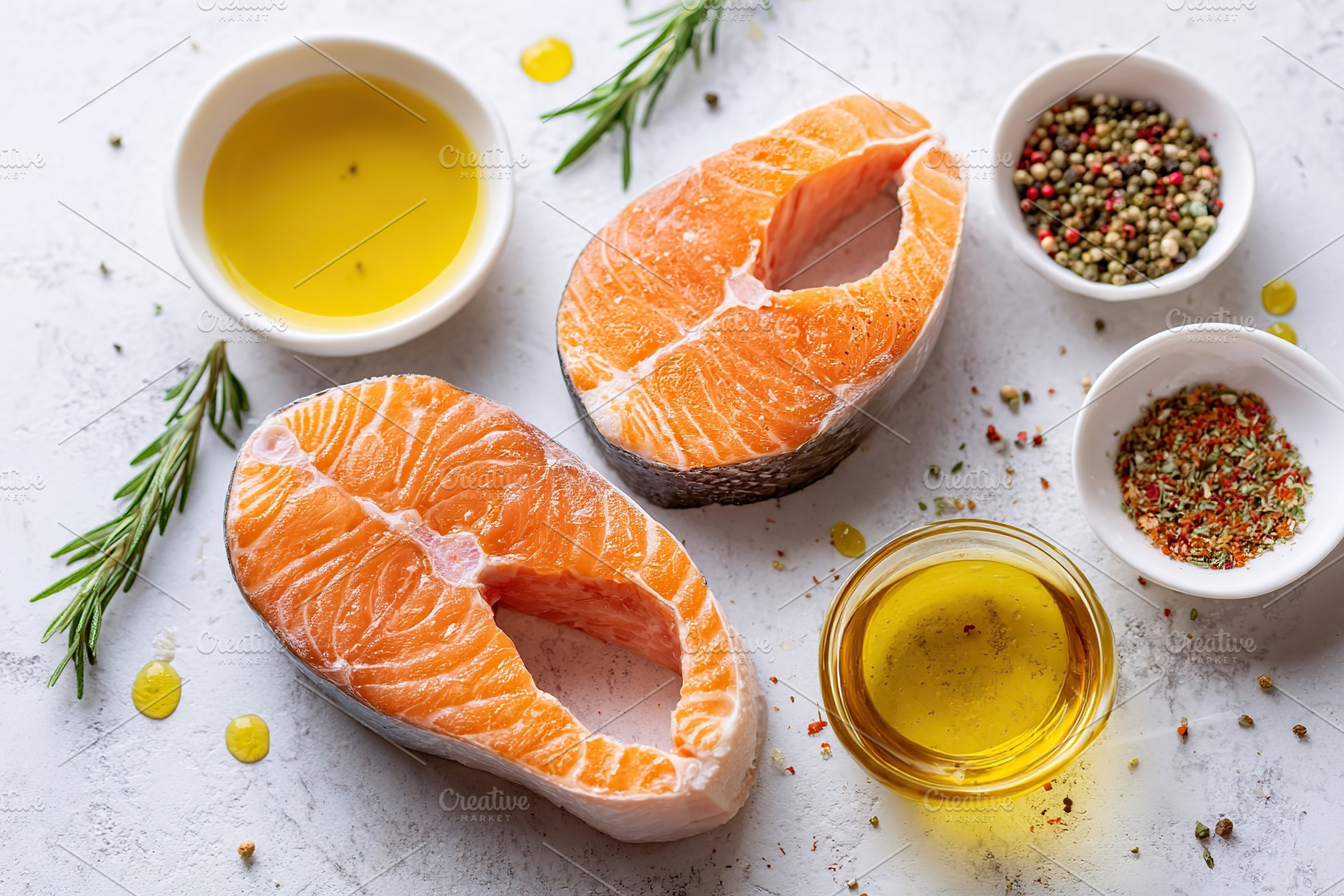 Fresh salmon steaks ready for seasoning and cooking with herbs and oils, a Food & Drink Photo by AlyaAnd