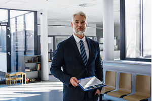 Confident senior manager holding, a Person Photo by HalfPoint