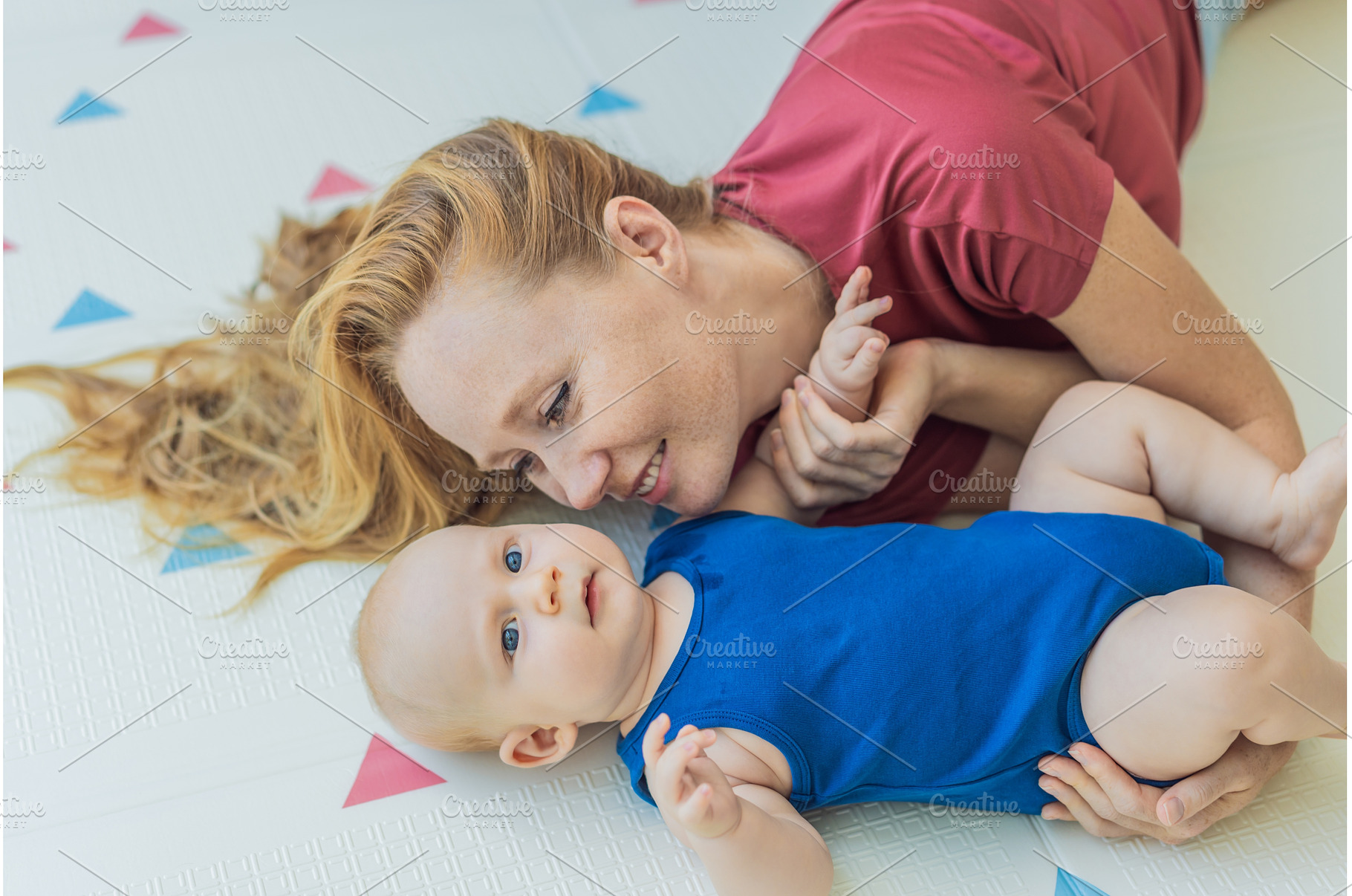 Mother and baby lying on a soft play, an Architecture Photo by Elizaveta Galitskaya