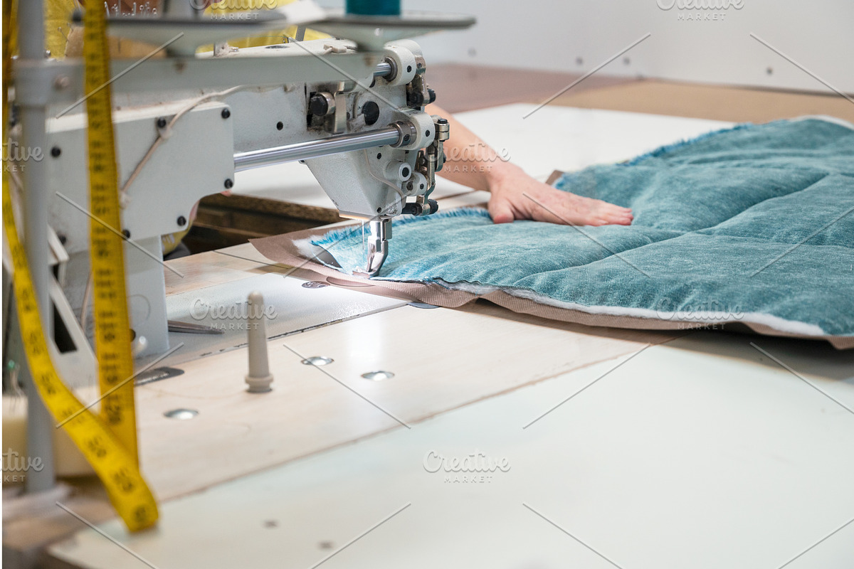 Tailor stitching furniture, a Graphic by Jan Jack Russo Media