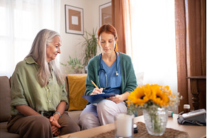 Nurse cosulting with senior her, a Person Photo by HalfPoint