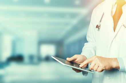 Unrecognizable male doctor in white coat with stethoscope using tablet, a Person Photo by Tinyakov Story