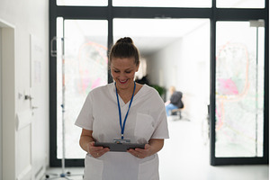 Portrait of nurse reading patient, a Health & Medical Photo by HalfPoint