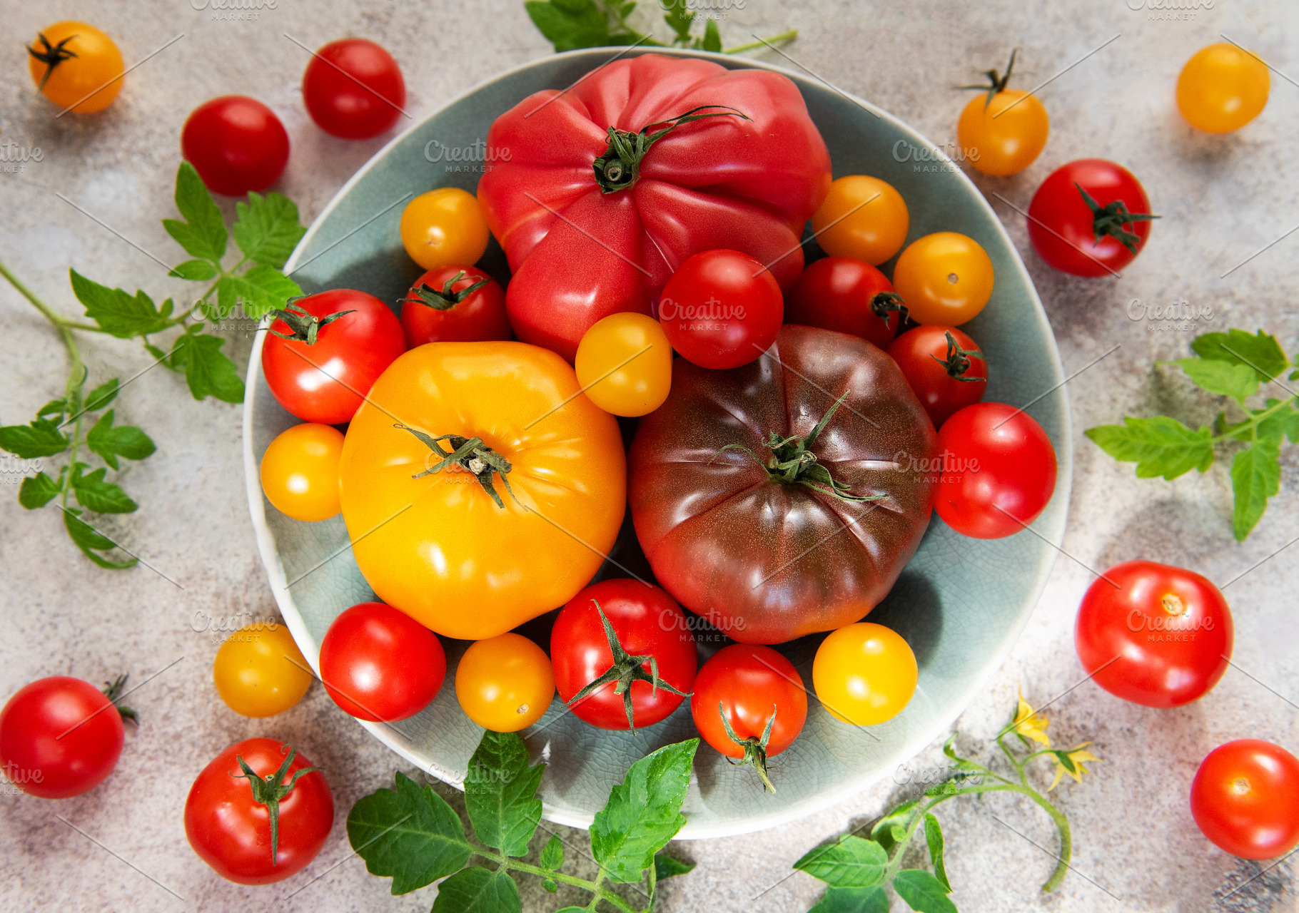 Fresh farm tomatoes displaying colorful variety on a plate, a Food & Drink Photo by Olena Rudo