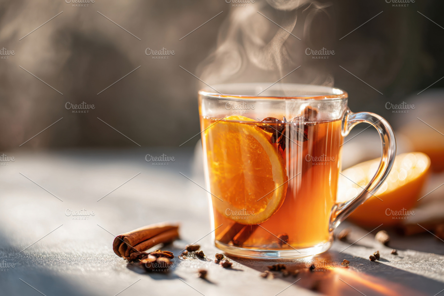 Steaming cup of spiced tea with orange and cinnamon, a Food & Drink Photo by AlyaAnd