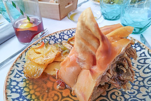 Roasted pork with crispy skin on traditional ceramic plate, a Food & Drink Photo by DanFLCreativo