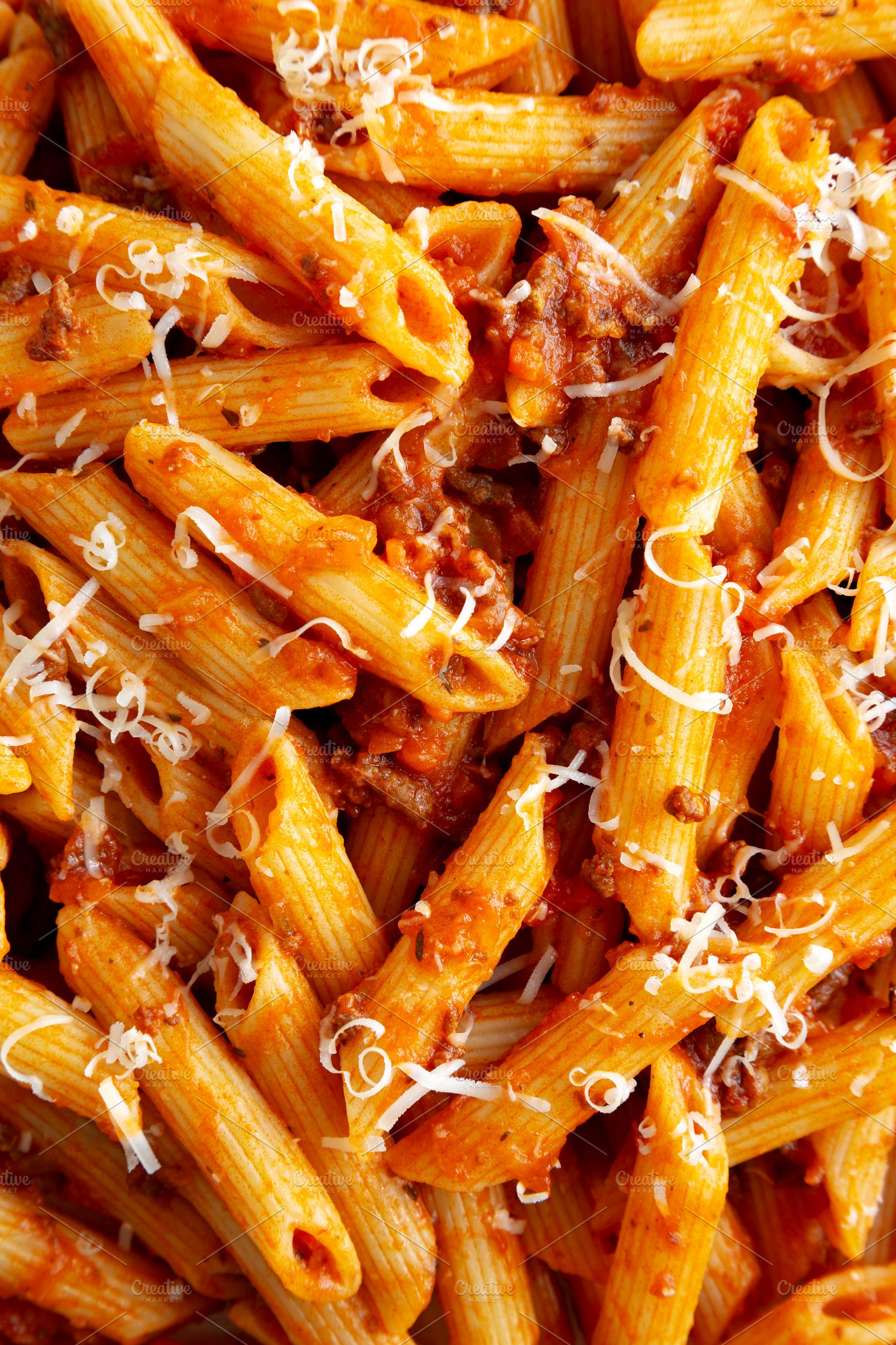 Homemade Pasta Bolognese with Cheese on a Plate, top view., a Food & Drink Photo by LiudmylaChuhunova
