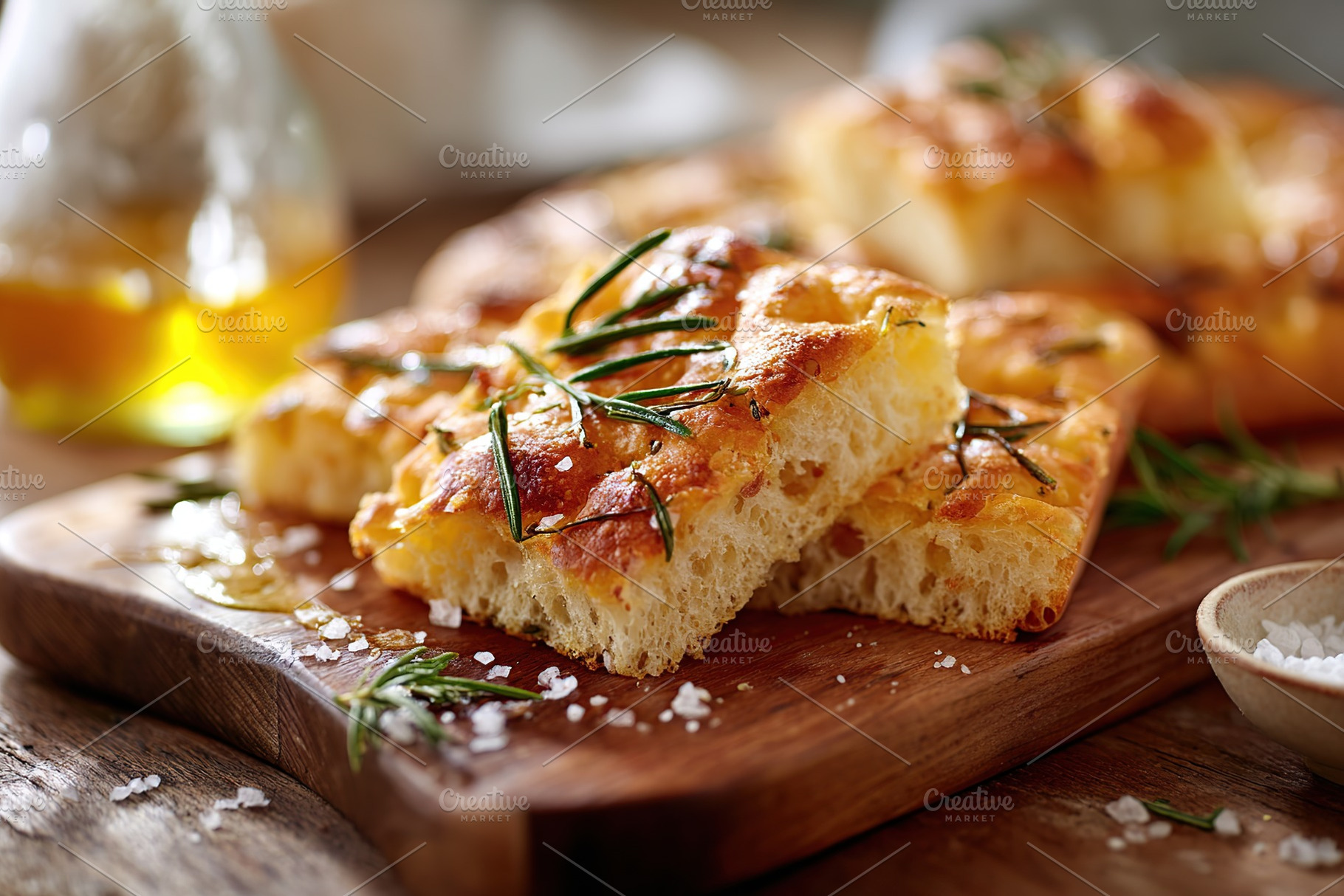 Baked focaccia bread topped with rosemary and sea salt on a wooden serving boar, a Food & Drink Photo by AlyaAnd