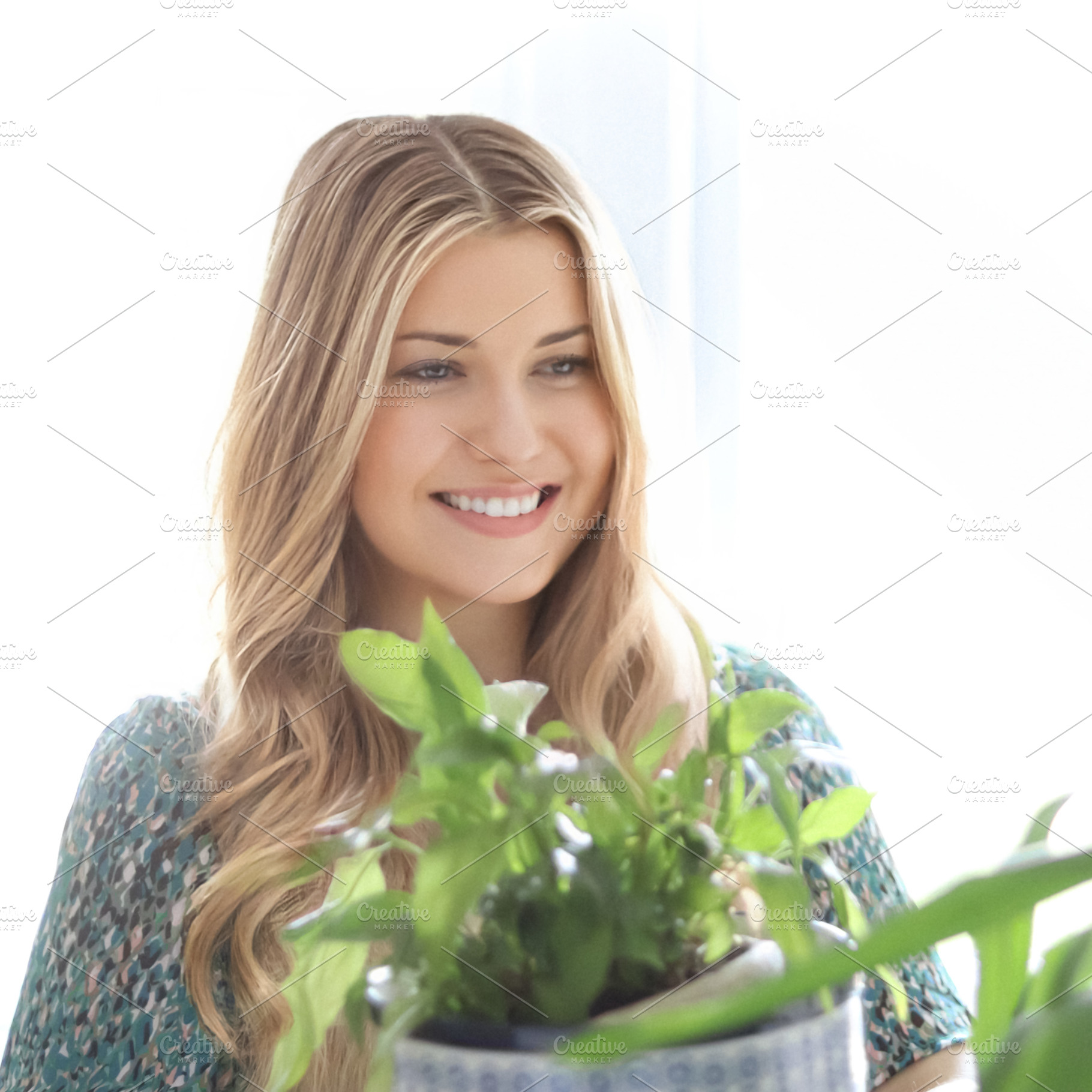 Woman smiling with long blonde hair, in a green dress and holdin, a Person Photo by Studio ANNA