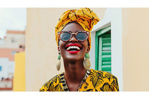 African woman wearing vibrant, a Beauty & Fashion Photo by Sergey Kotenev