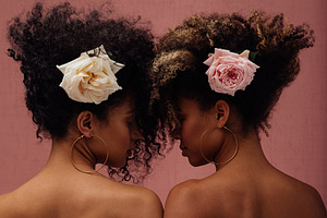 Two females with flowers, a Person Photo by Artem Varnitsin