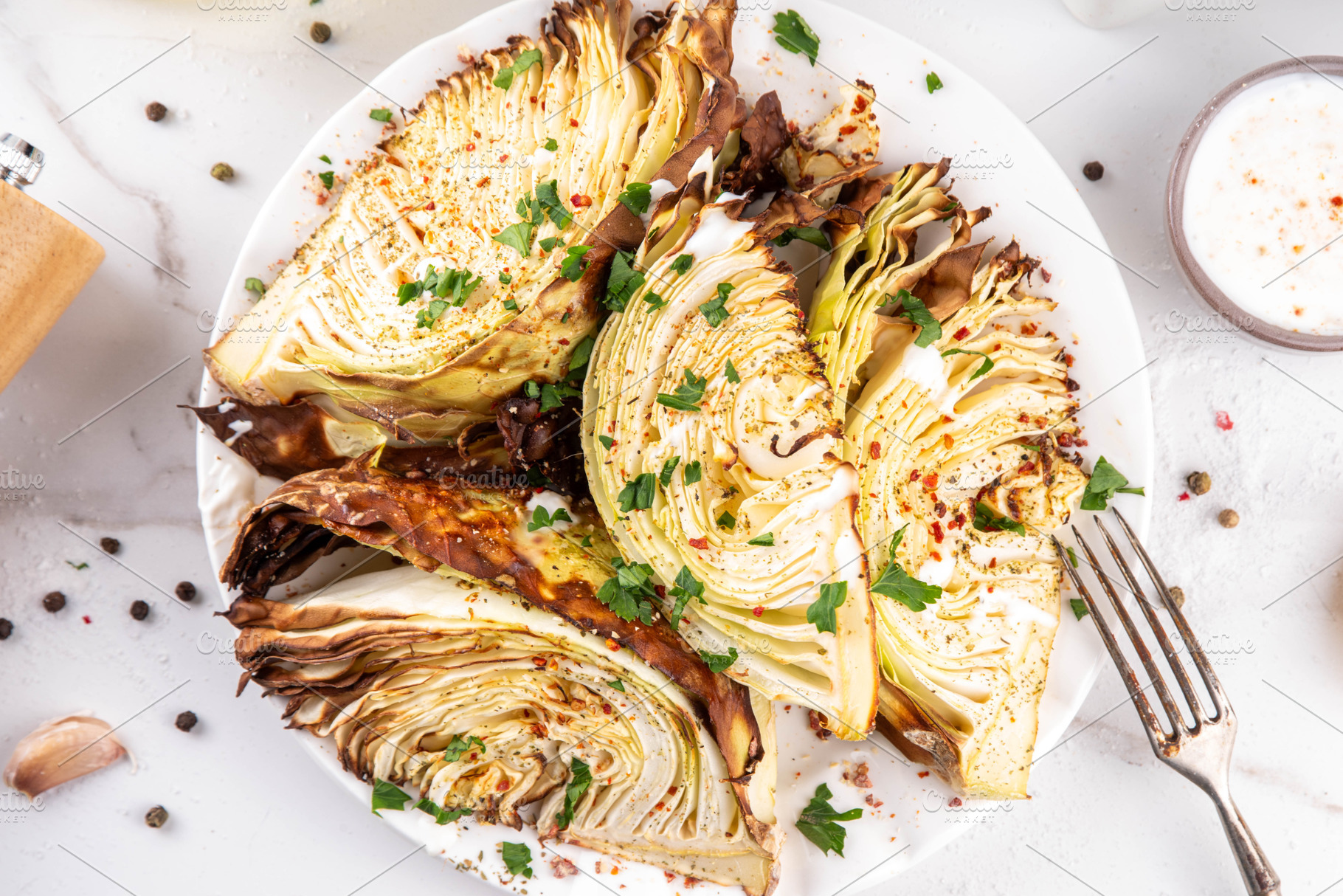 Roasted baked cabbage with cheese and aromatic herbs, a Food & Drink Photo by Rimma