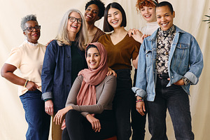 Portrait of mixed age range multi ethnic women smiling in celebration of Intern