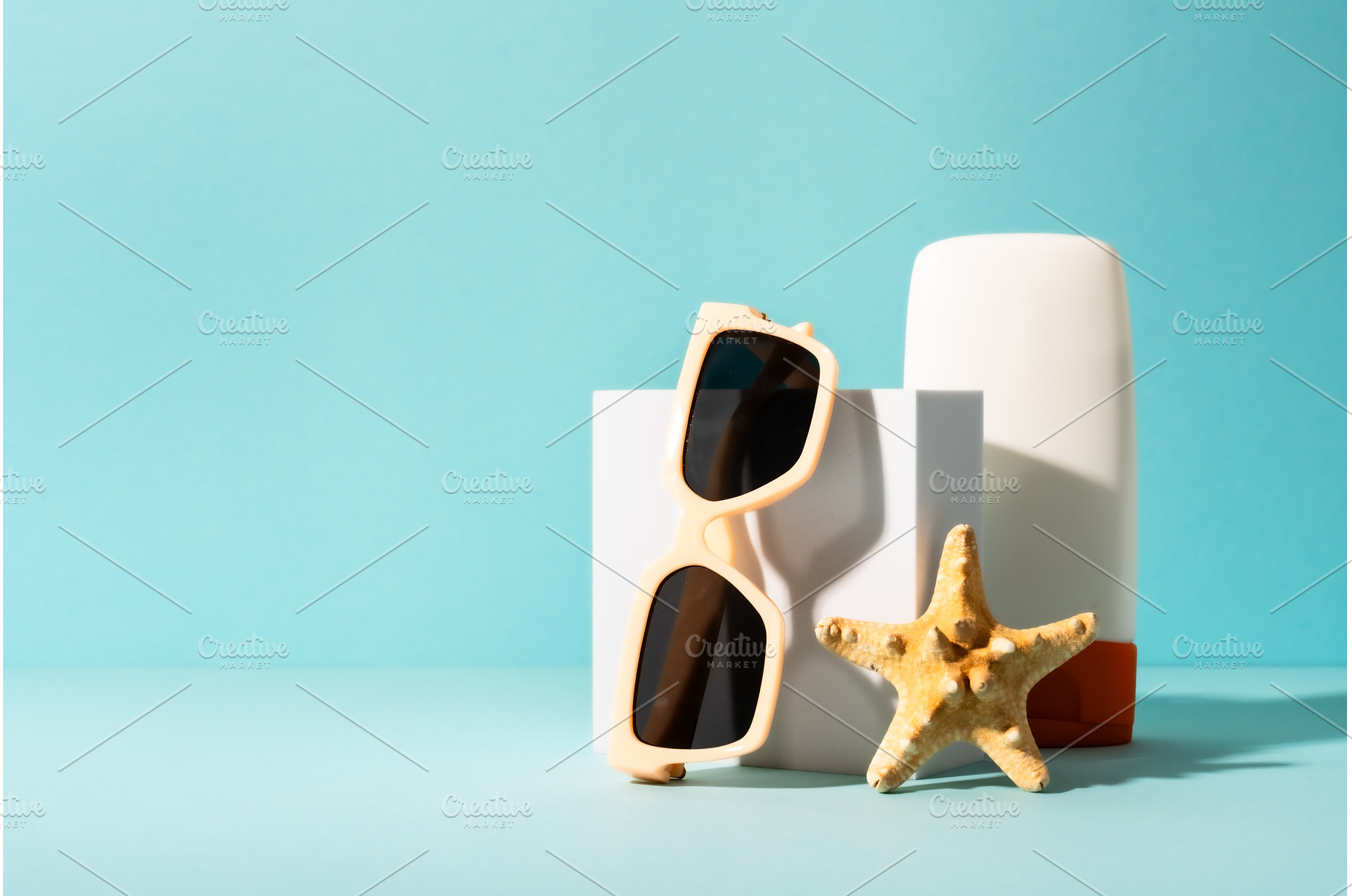 Sunglasses on white podium, a Nature Photo by Nadia-nb