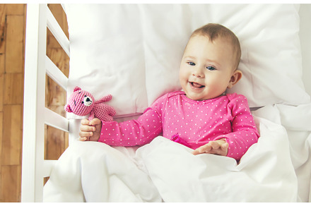 Baby toddler plays in the crib, a Person Photo by yanadjana