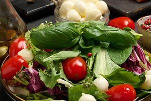 Close-up of a plate with fresh lettuce, cherry tomatoes, mozzare, a Food & Drink Photo by ndanko